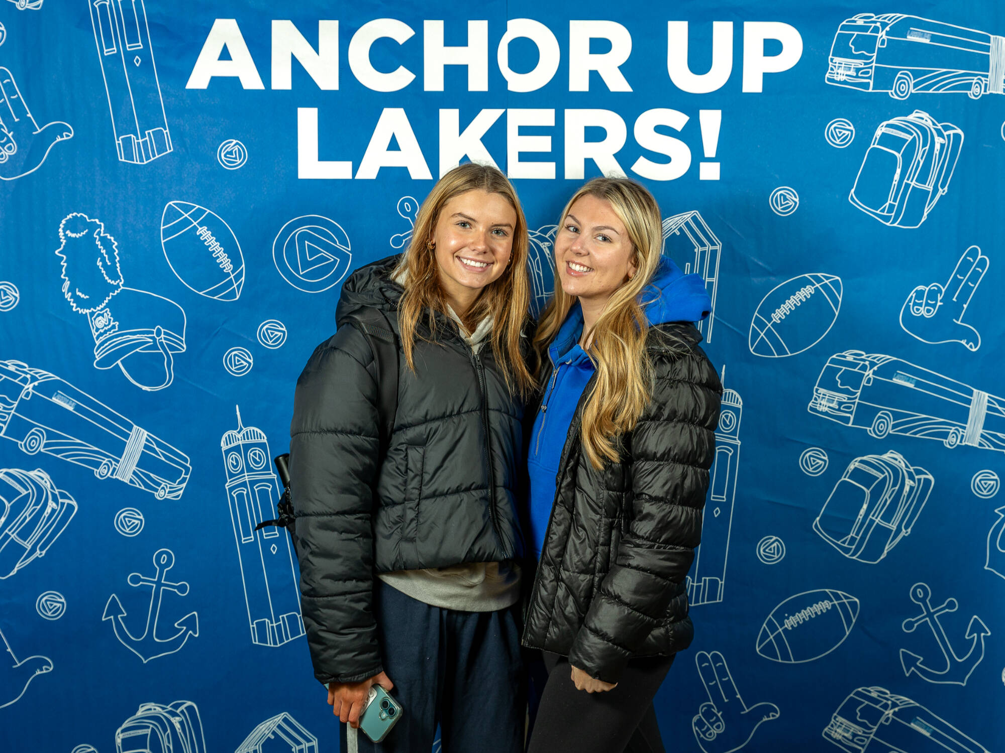 two individuals wearing black puffer jackets